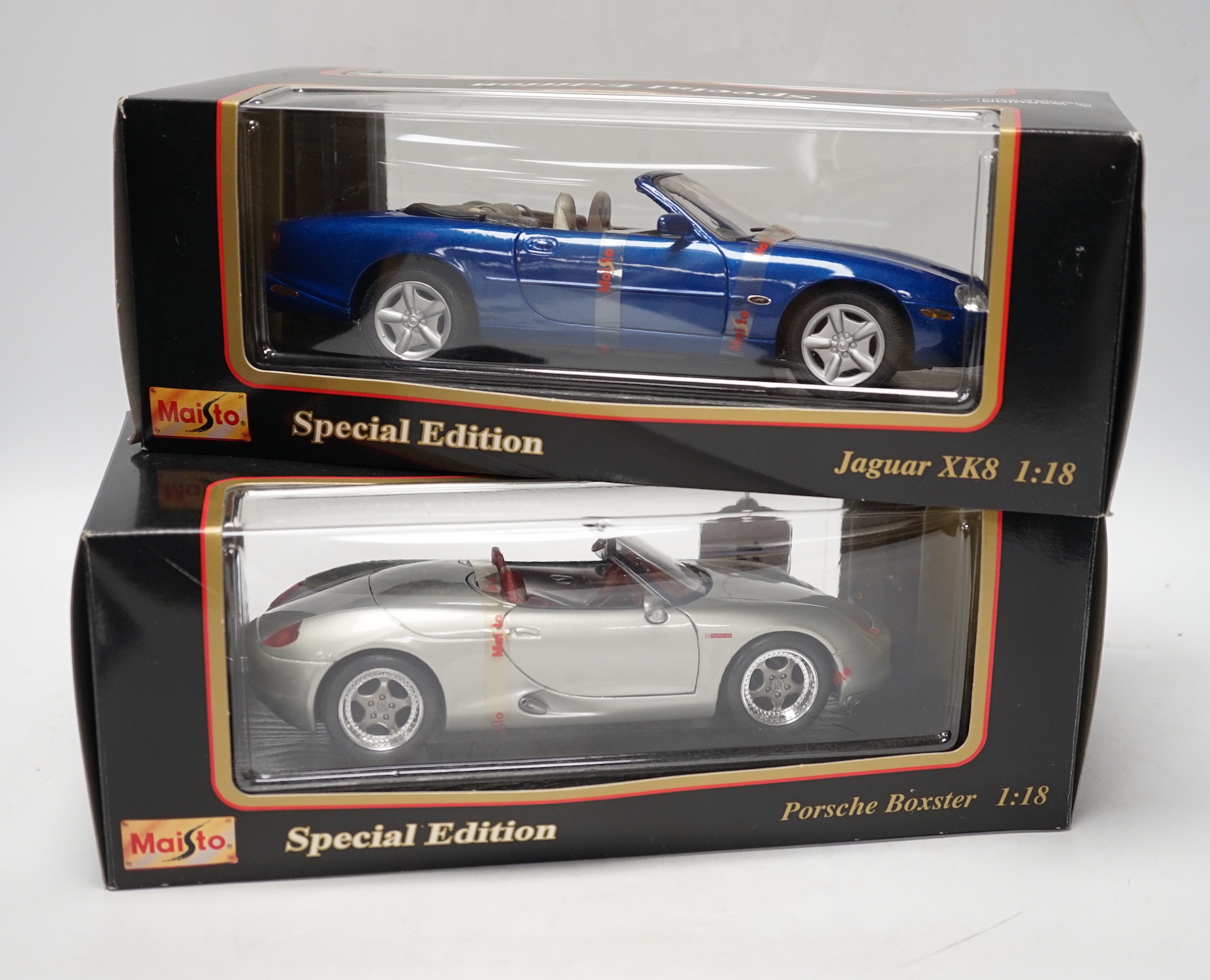 Five boxed Maisto 1:18 model cars; Porsche Boxster, Ferrari 550 maranello, Jaguar XK8, Dodge Concept vehicle and a Jaguar XJ220